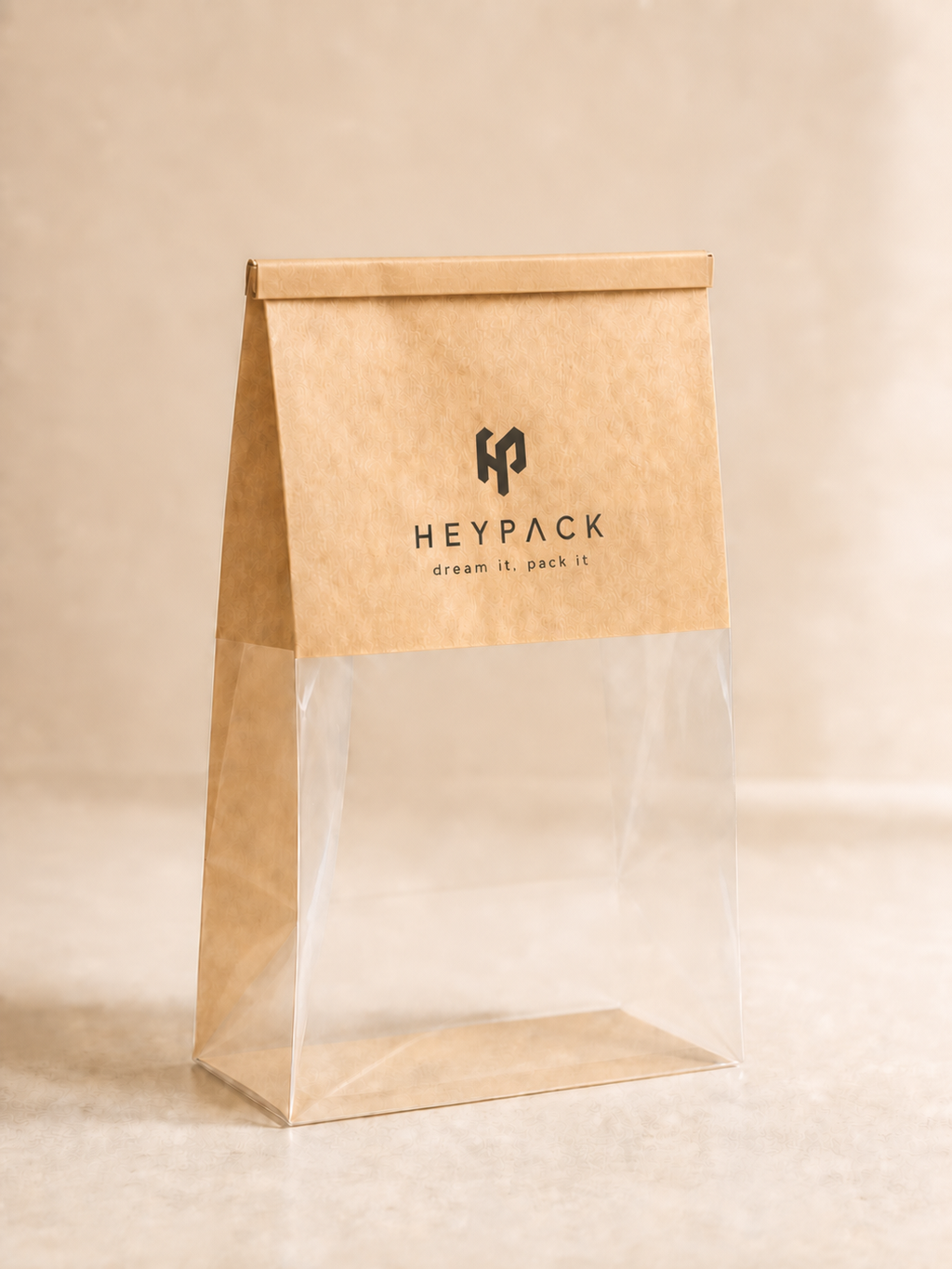 Custom kraft and clear bakery bag with HeyPack branding and flat rolled tin-tie closure