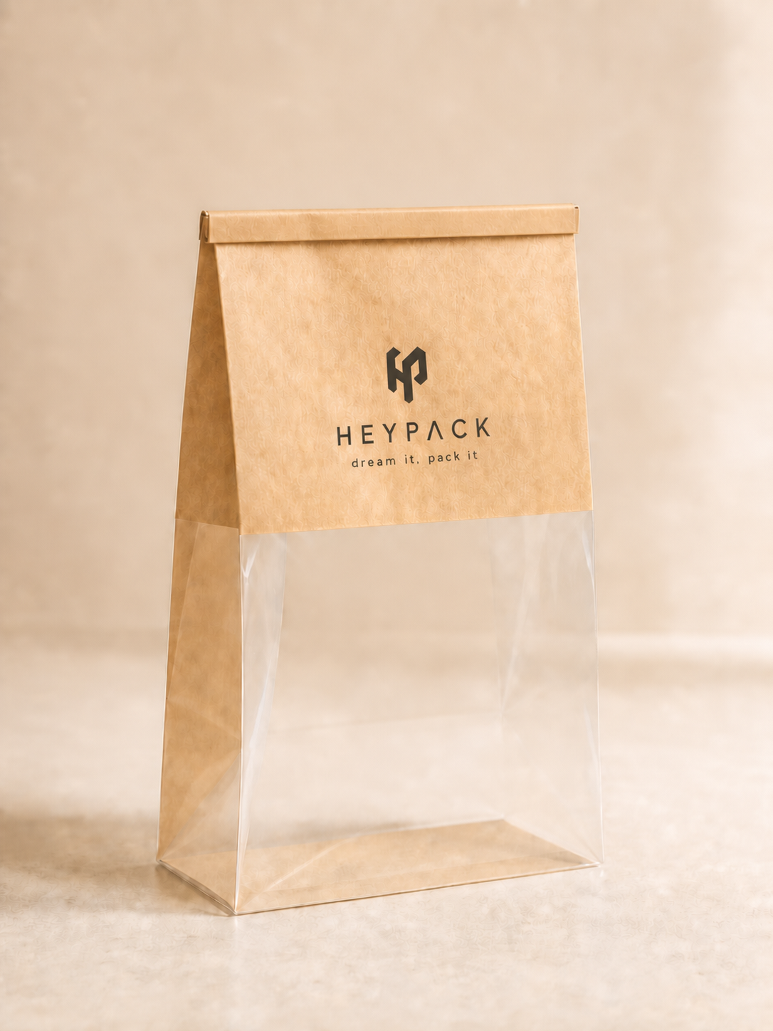 Custom kraft and clear bakery bag with HeyPack branding and flat rolled tin-tie closure